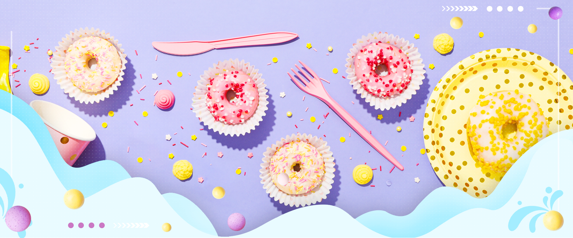 Colorful sprinkles adorn a delightful assortment of donuts, each meticulously decorated with icing and sanding sugar for an enchanting visual treat.